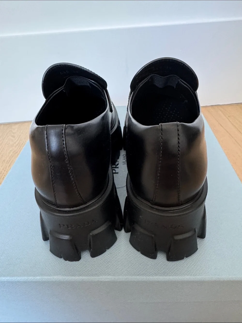 Prada Monolith leather loafer with rubber sole.